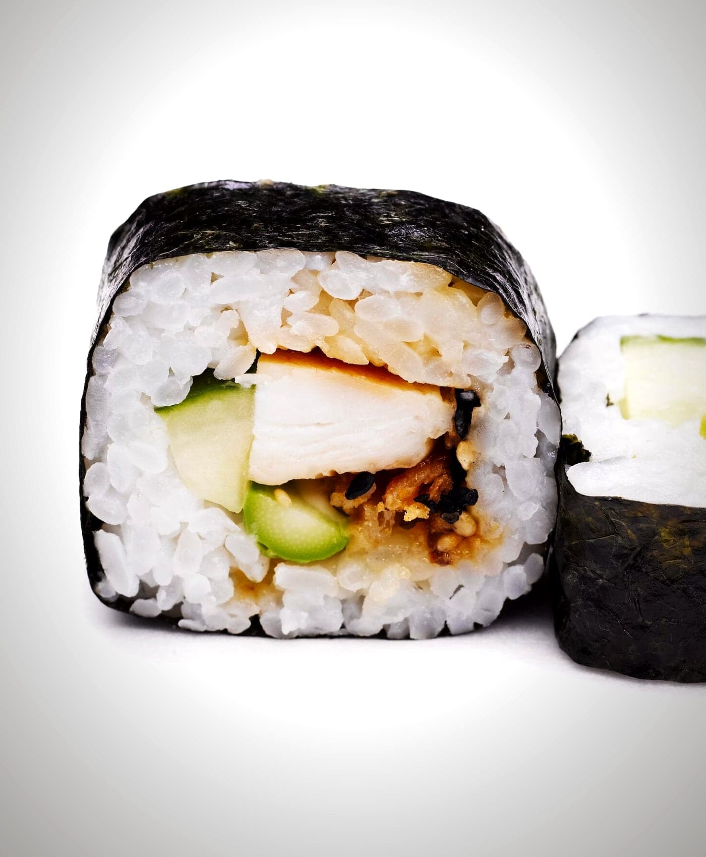 The Dragon roll at Daisuki Sushi, topped with sliced avocado in a dragon-scale pattern.